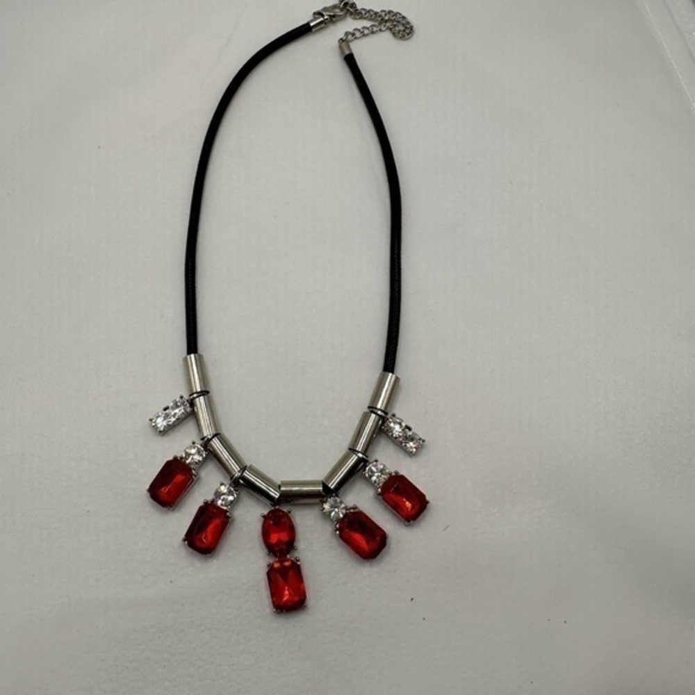 Beautiful necklace with red stones and diamonds in a black background
